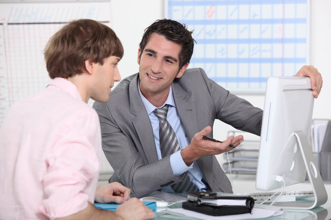 man explaining something in computer