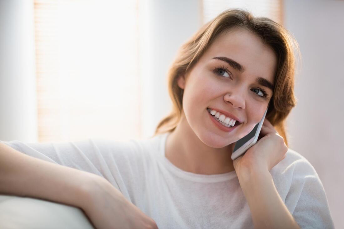 woman smiling taking phone call